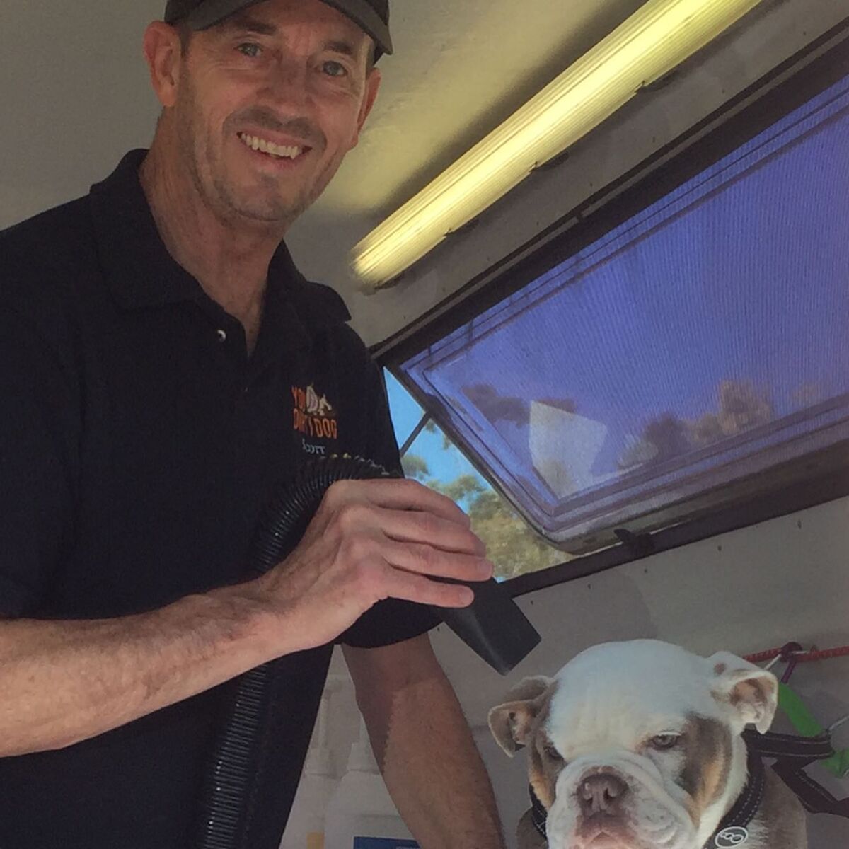 Scott drying Reggie inside the trailer